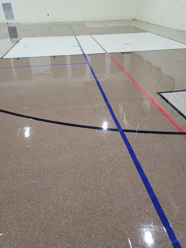 A basketball court with blue and red lines on it