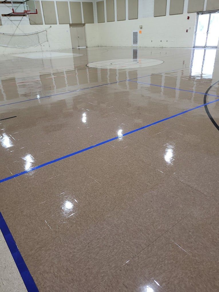 A basketball court with a blue line on the floor.