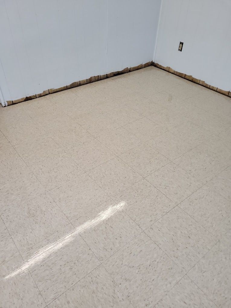 A room with a white tile floor and white walls.