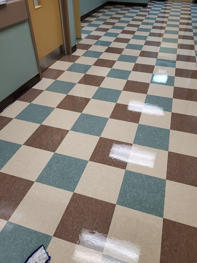 A hallway with a checkered floor and a door