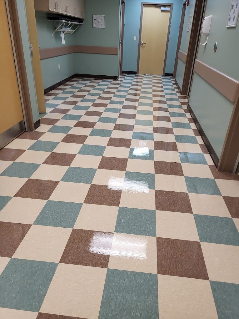 A hallway with a checkered floor in a hospital