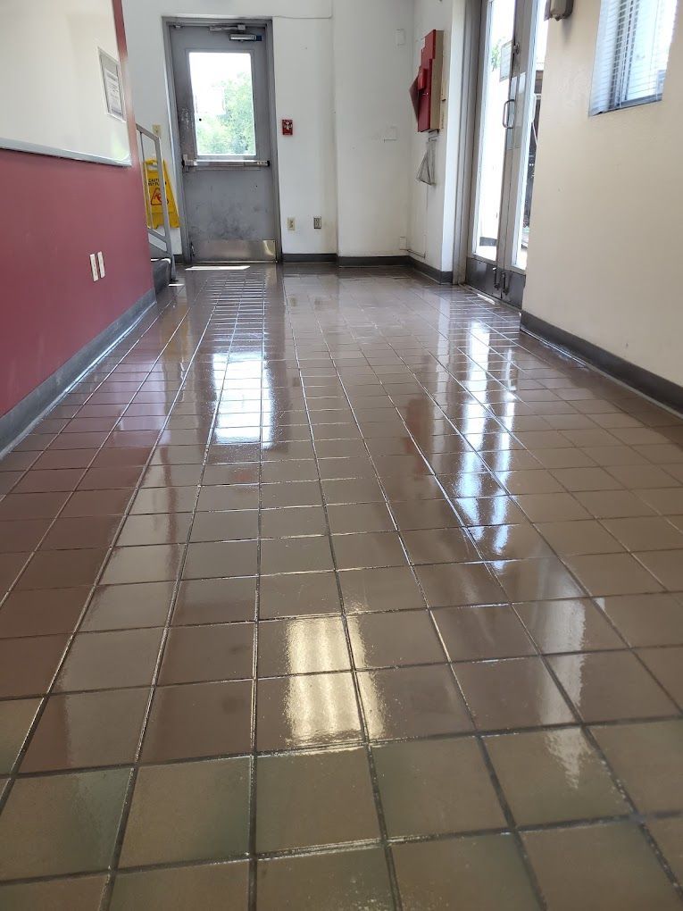 A hallway with a tiled floor and a door