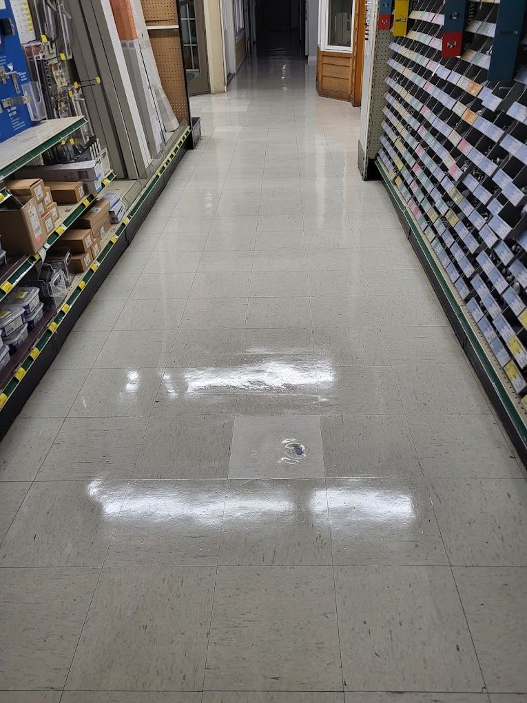 A long hallway in a hardware store with lots of shelves.