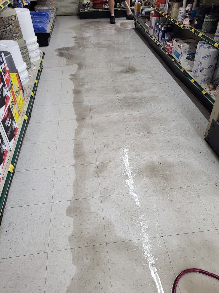 A person is walking down a wet floor in a store.