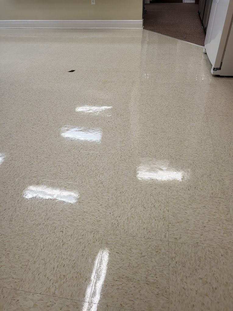A close up of a shiny floor in a room.