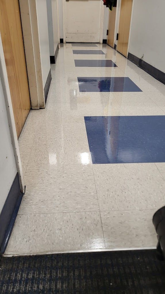 A long hallway with a blue and white tile floor.