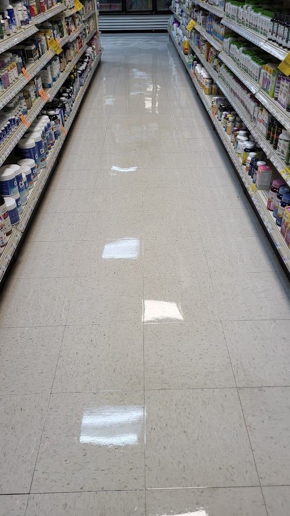 A row of shelves in a grocery store filled with lots of products.