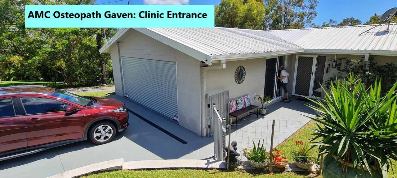 A person walking through the entrance doorway at osteopathy clinic at Gaven on the Gold Coast