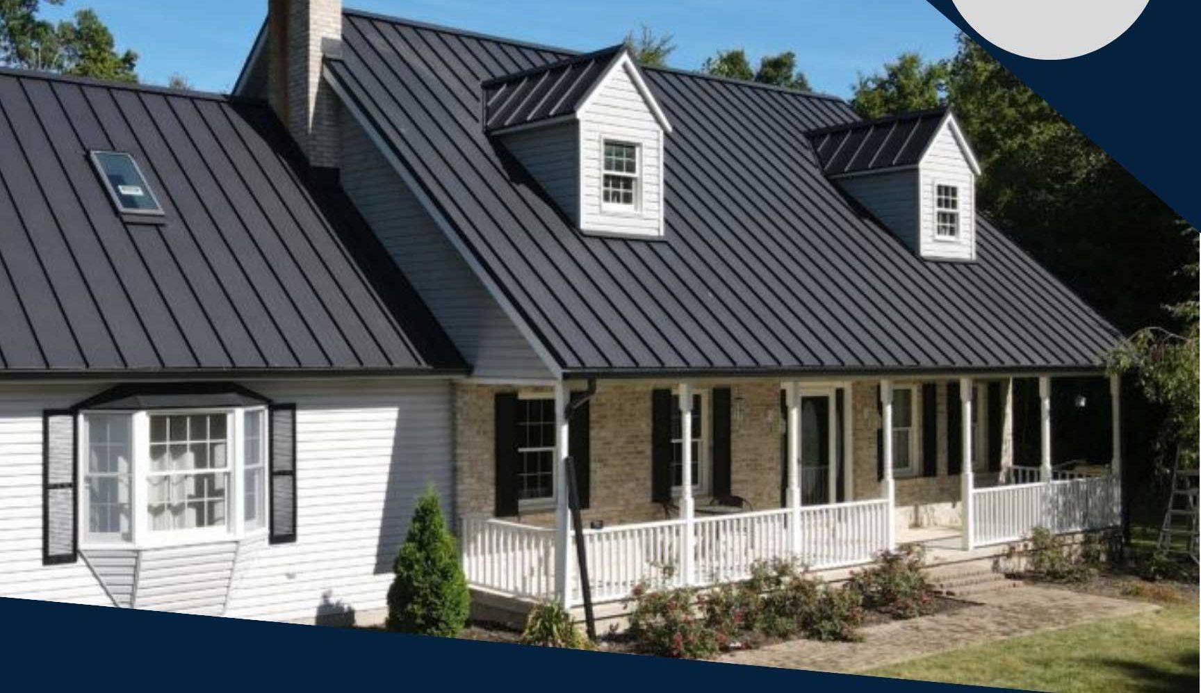 A white house with a black roof and a standing seam roof