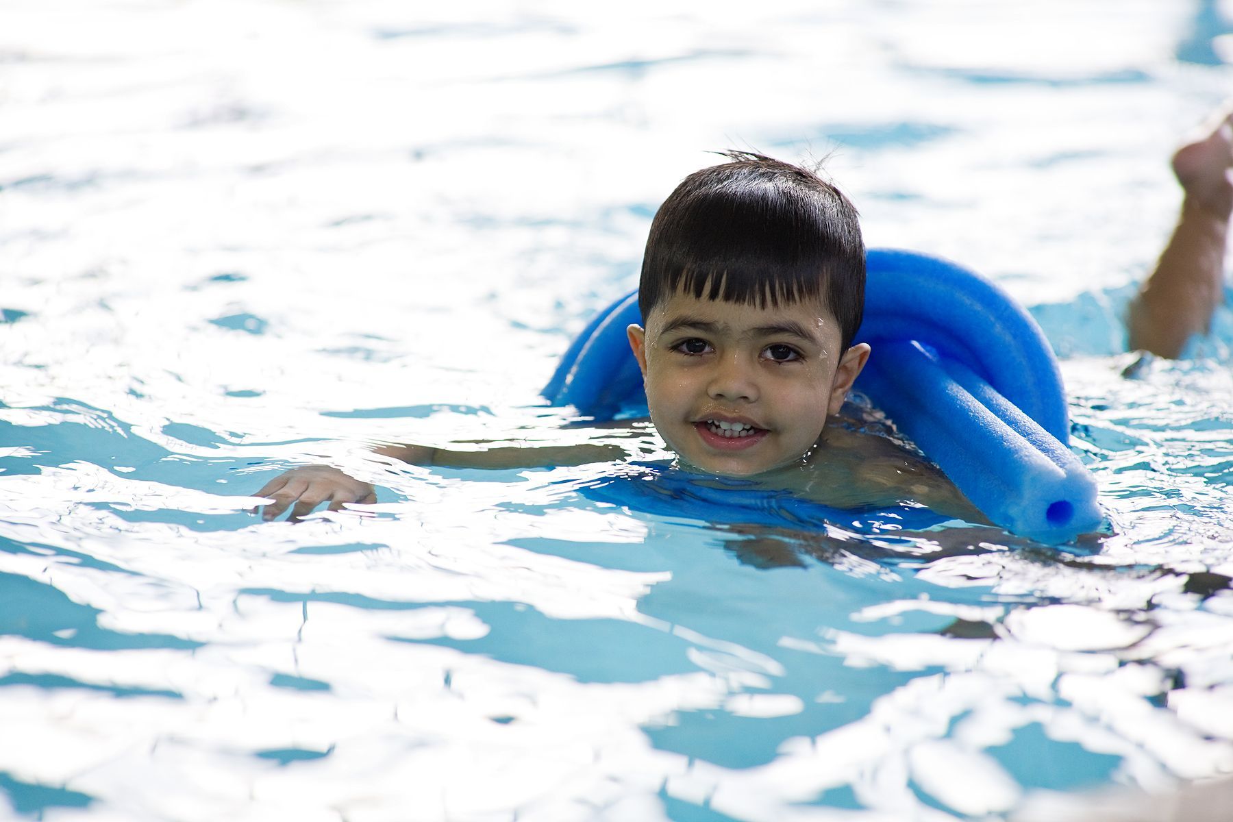 Young boy learning how to swim