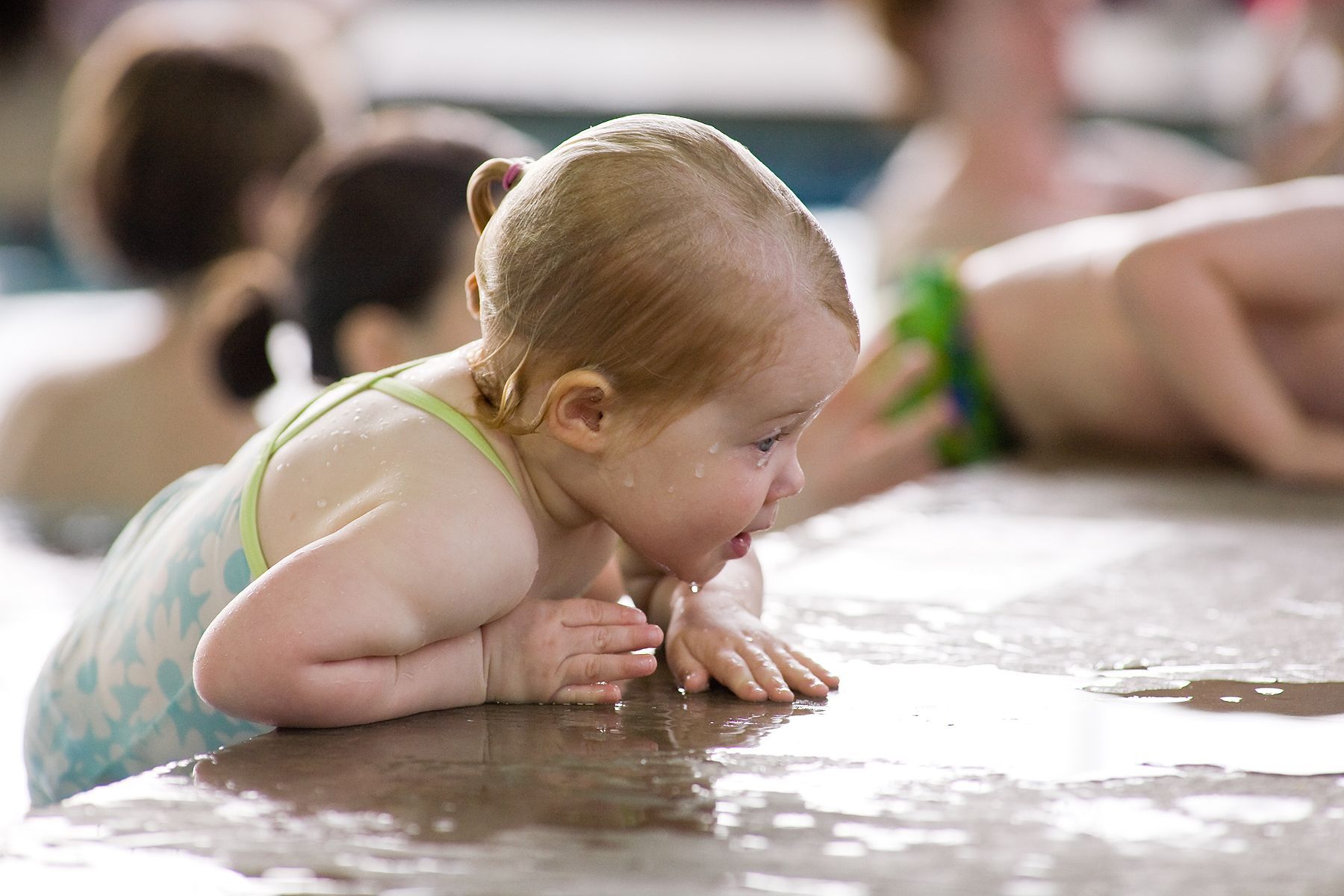 Child climbing out of swimming pool