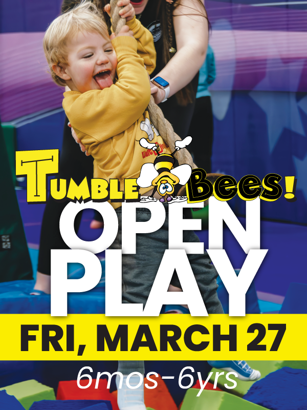 Child at Tumble Bees open play, pulling on rope. Yellow shirt, open mouth, grinning. Purple, green, blue background.