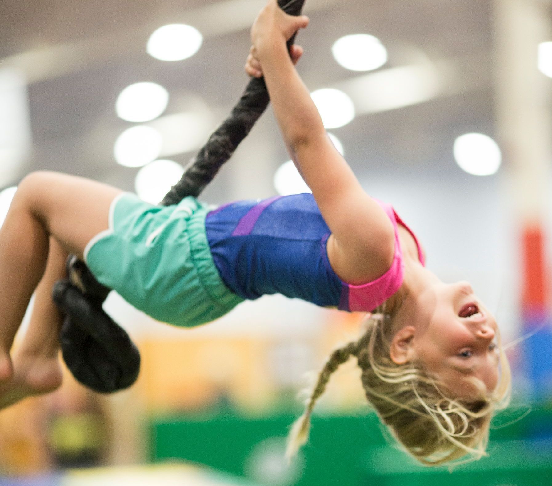 Happy Child swinging on a rope