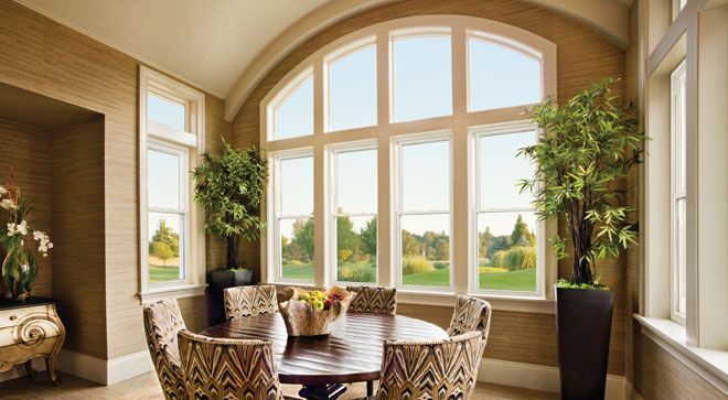A brick house with a sliding glass door and a clock on the wall.
