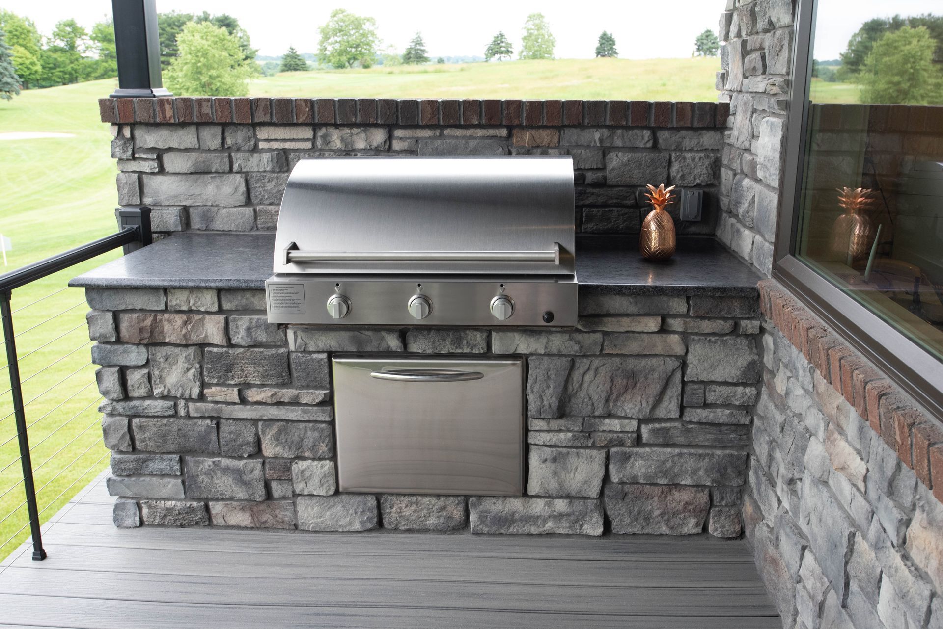 A man and a child are standing in front of a barbecue grill.