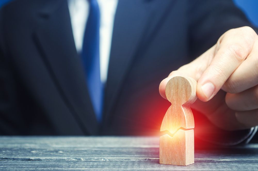 A Woman Is Sitting On The Floor Next To A Bed — Noosa Psychological Services in Noosa Heads, QLD