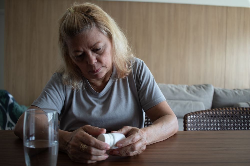 A Man And A Woman Are Sitting On A Couch Talking To Each Other — Noosa Psychological Services in Noosa Heads, QLD