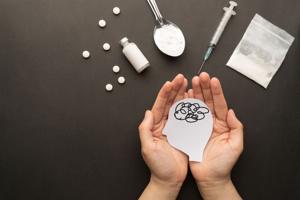 A Man Wearing An Oxygen Mask Is Leaning Against A Tree — Noosa Psychological Services in Noosa Heads, QLD