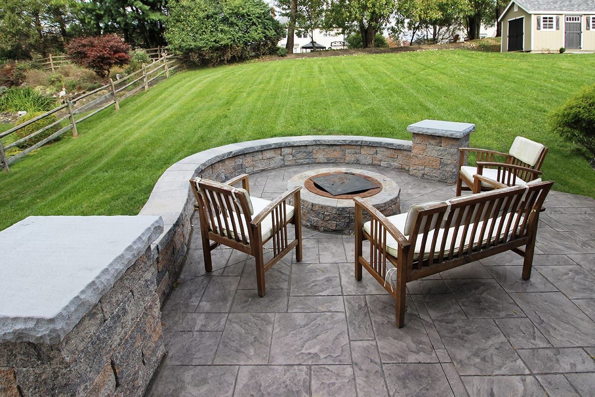 new stamped concrete patio with a fire pit in Hudson