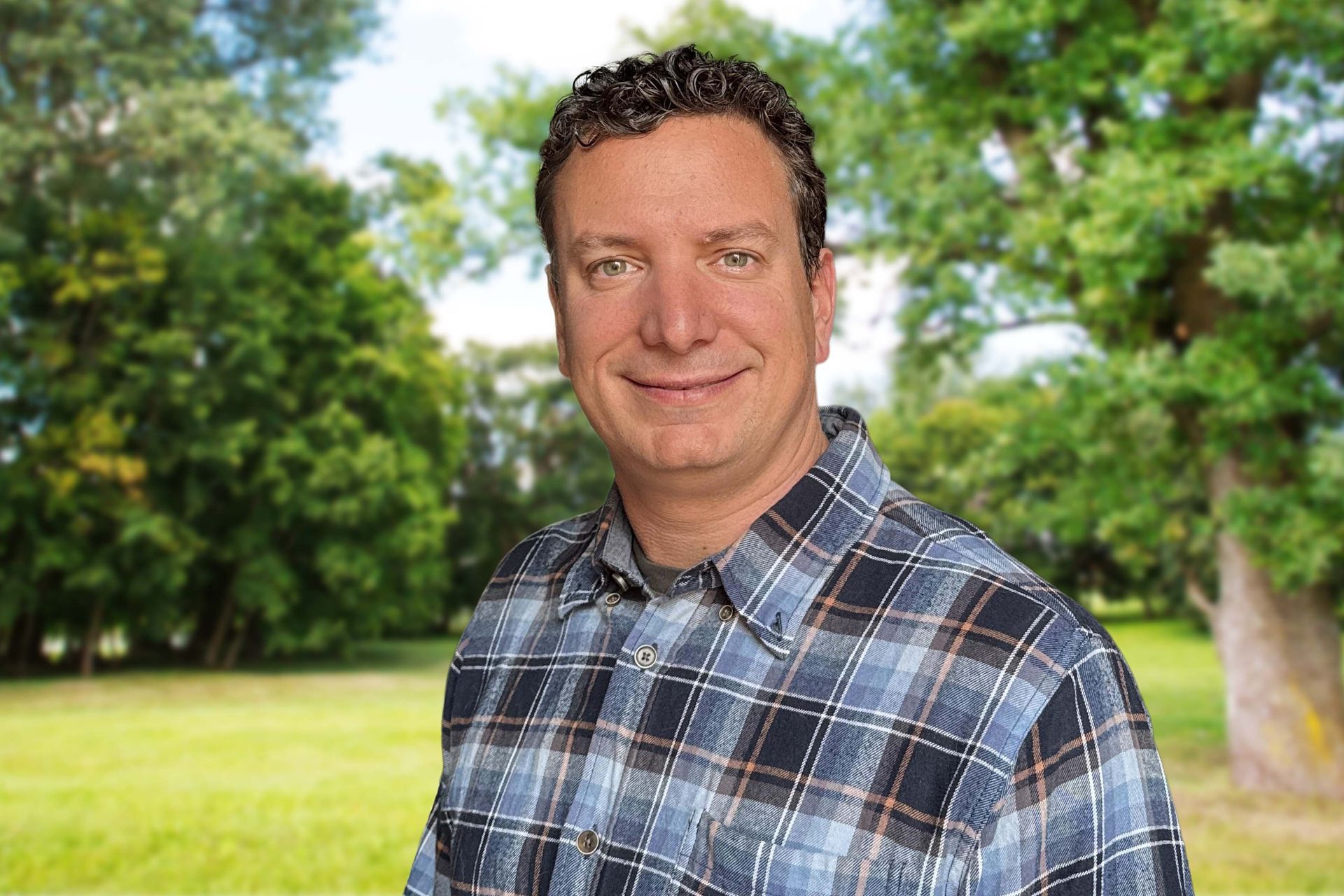 A woman with a tattoo on her arm is smiling for the camera