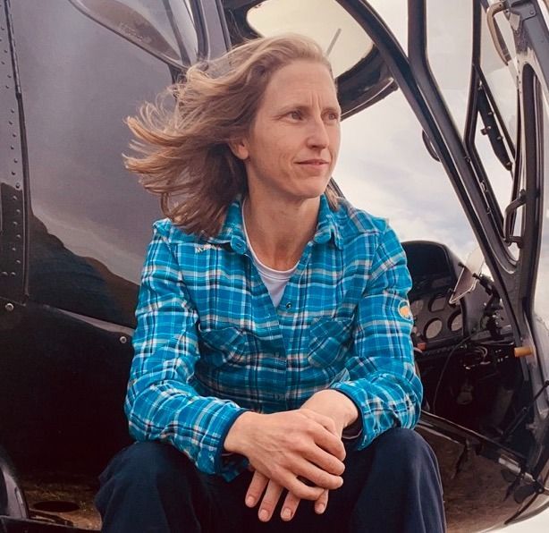 A man with dreadlocks and a beard is smiling for the camera.