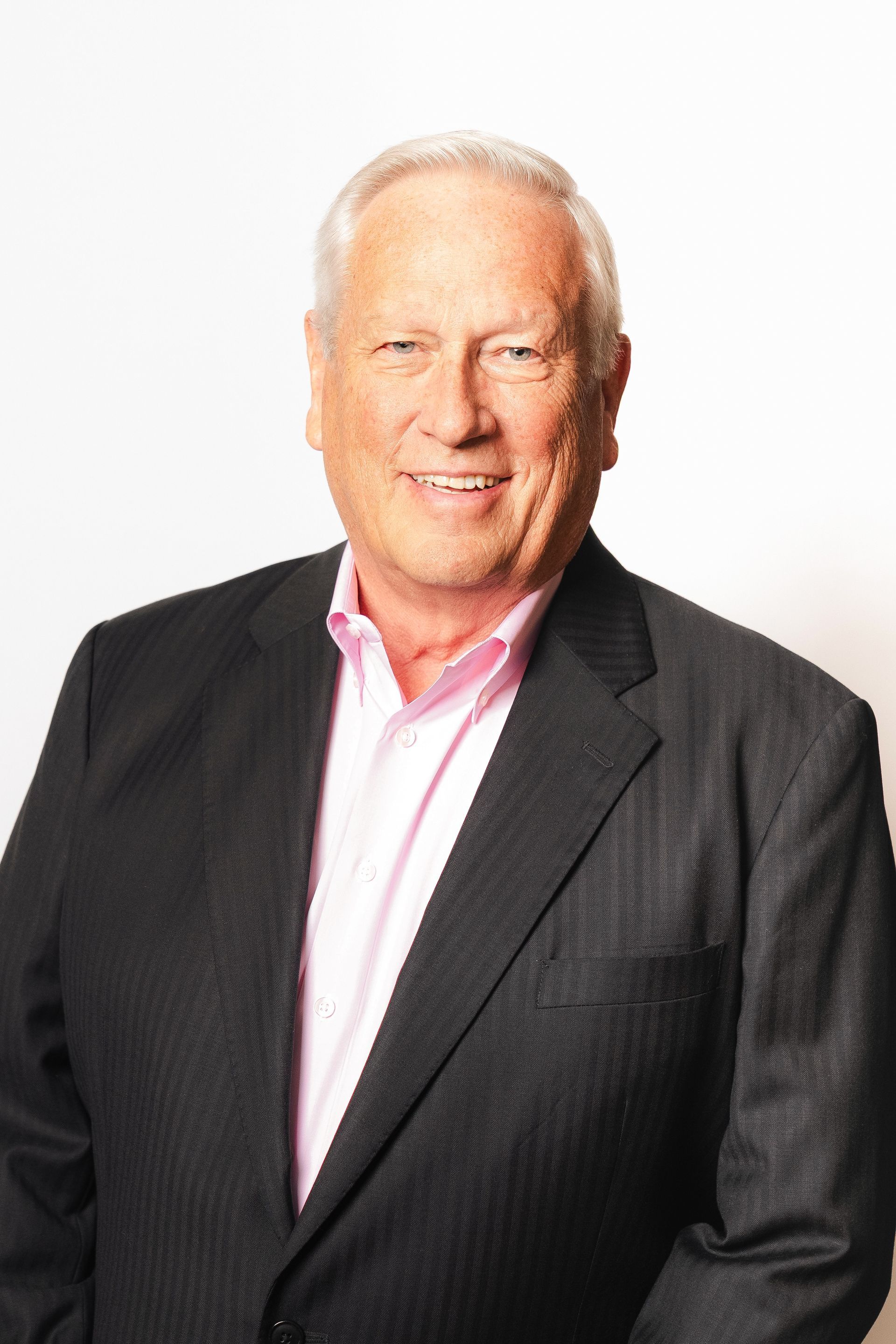 A woman with a tattoo on her arm is smiling for the camera