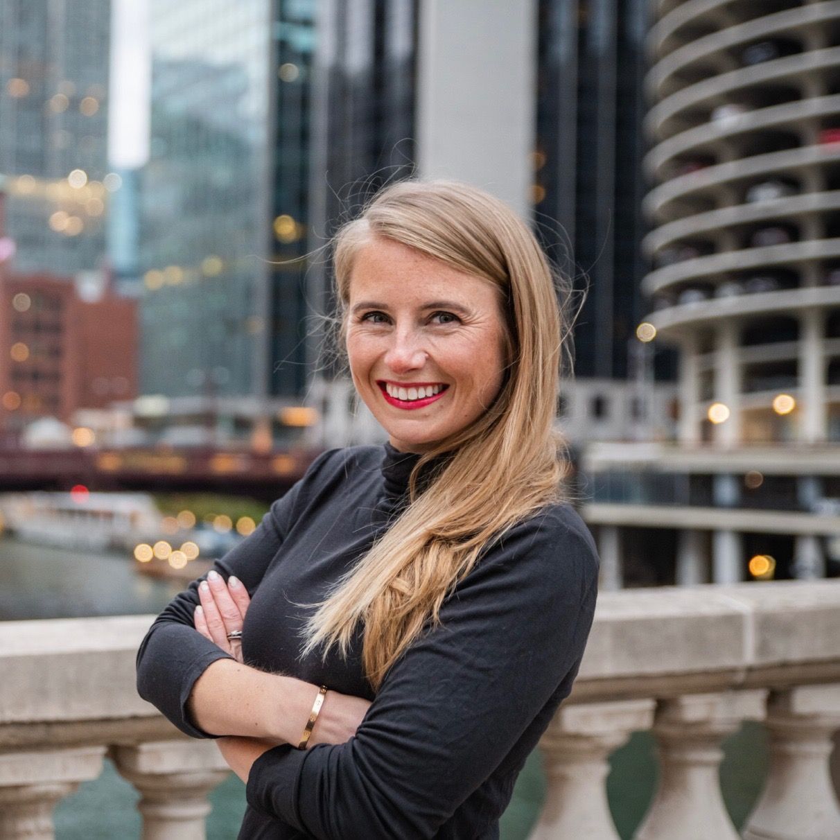 A woman with a tattoo on her arm is smiling for the camera