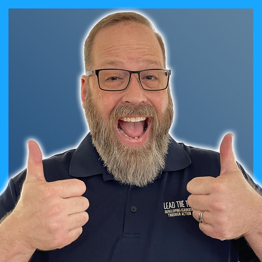 A woman in a pink dress is blowing a kiss while holding a microphone.