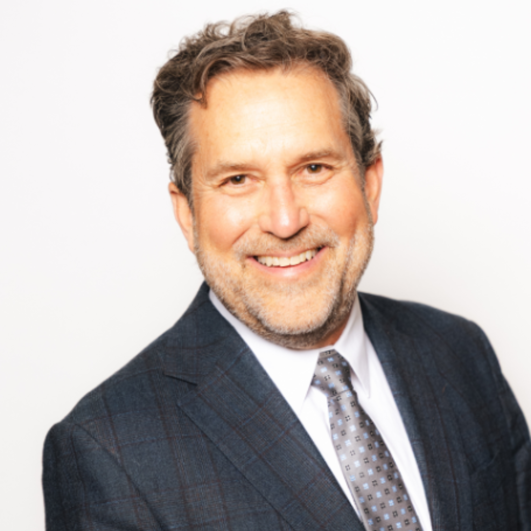 A woman in a pink dress is blowing a kiss while holding a microphone.