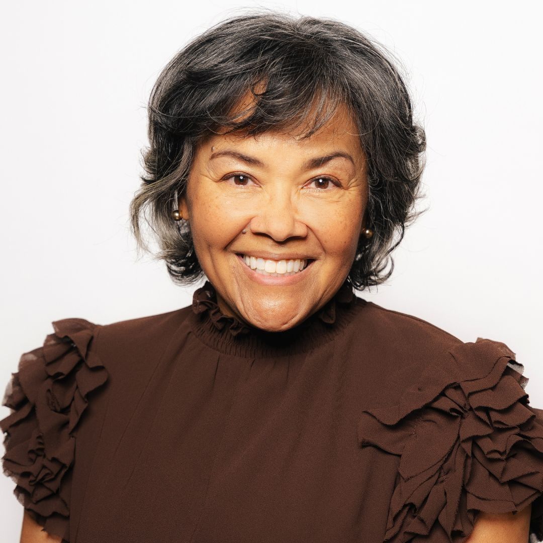 A man with dreadlocks and a beard is smiling for the camera.