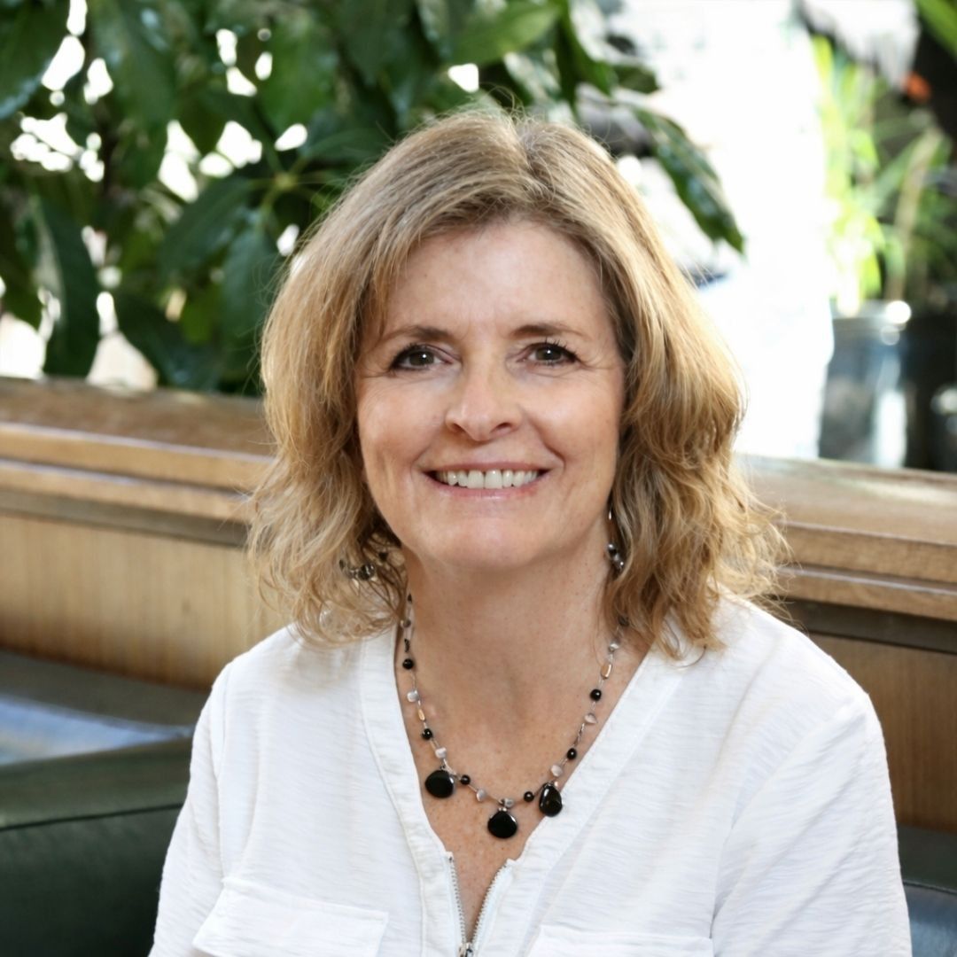 A man with dreadlocks and a beard is smiling for the camera.