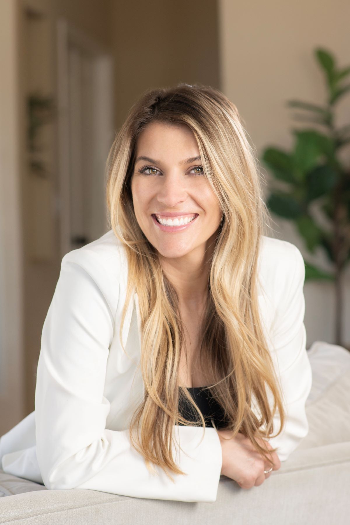 A woman with a tattoo on her arm is smiling for the camera