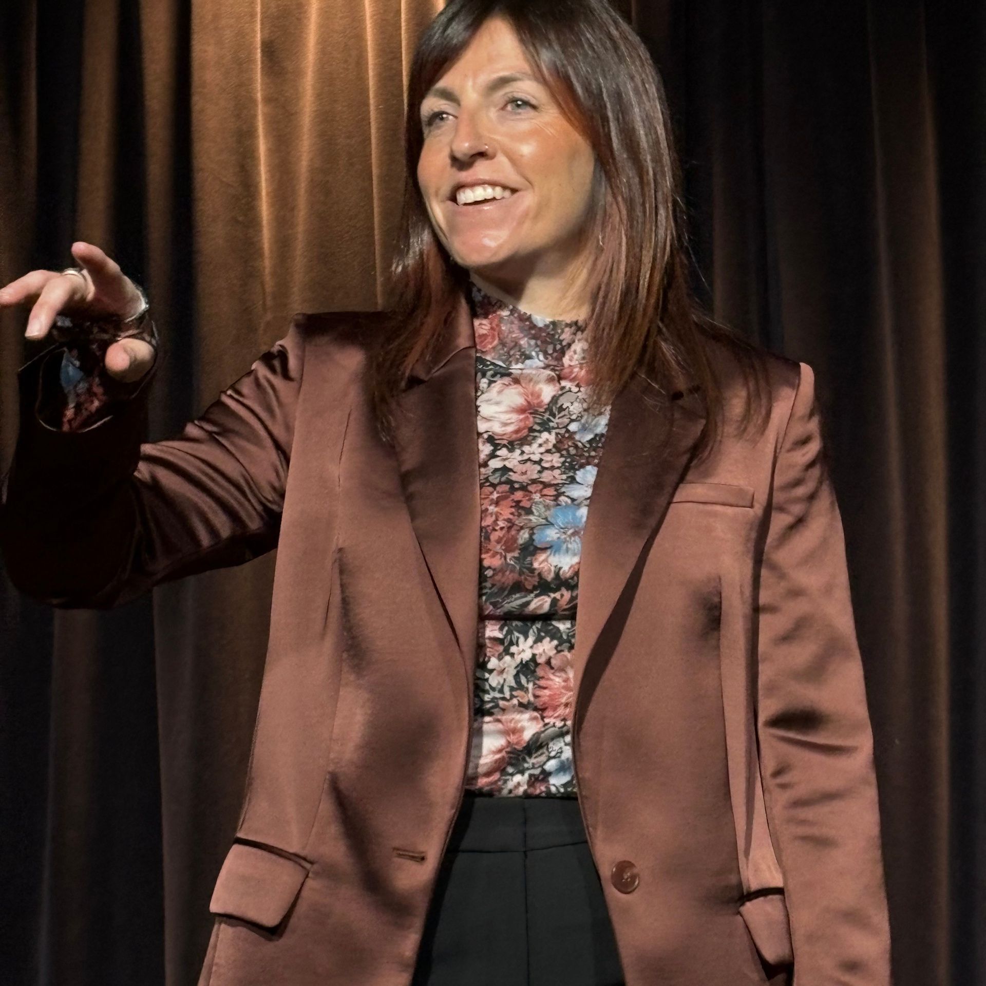 A woman with a tattoo on her arm is smiling for the camera