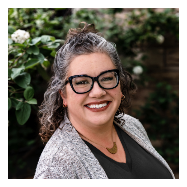 A man with dreadlocks and a beard is smiling for the camera.