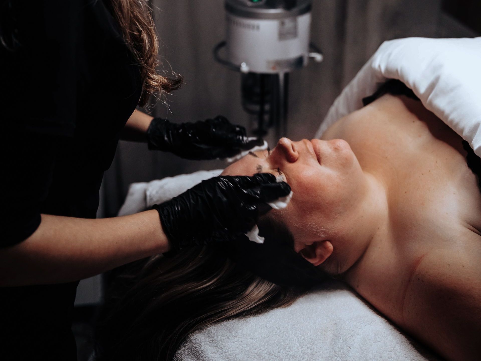 A woman is getting a facial treatment at a spa.