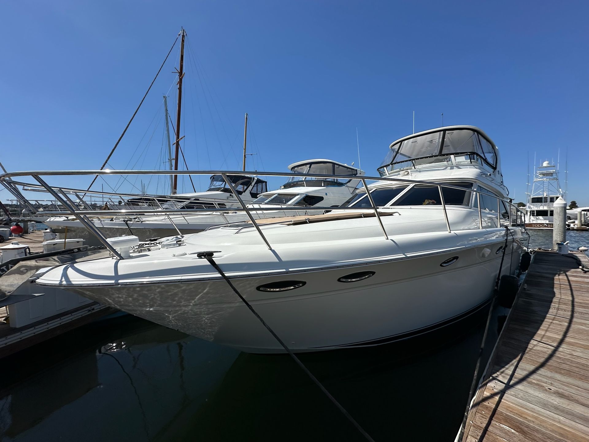A large white yacht is floating on top of a body of water.