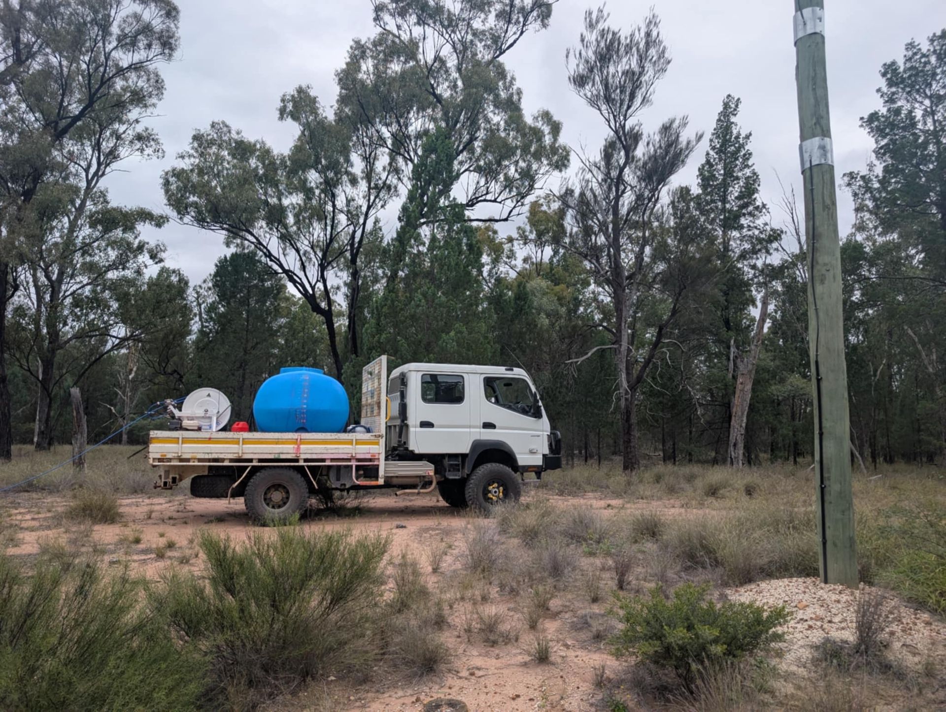 A Tractor is Cutting Grass in a Field — 2K Pasture Management and Consulting In Warwick, QLD
