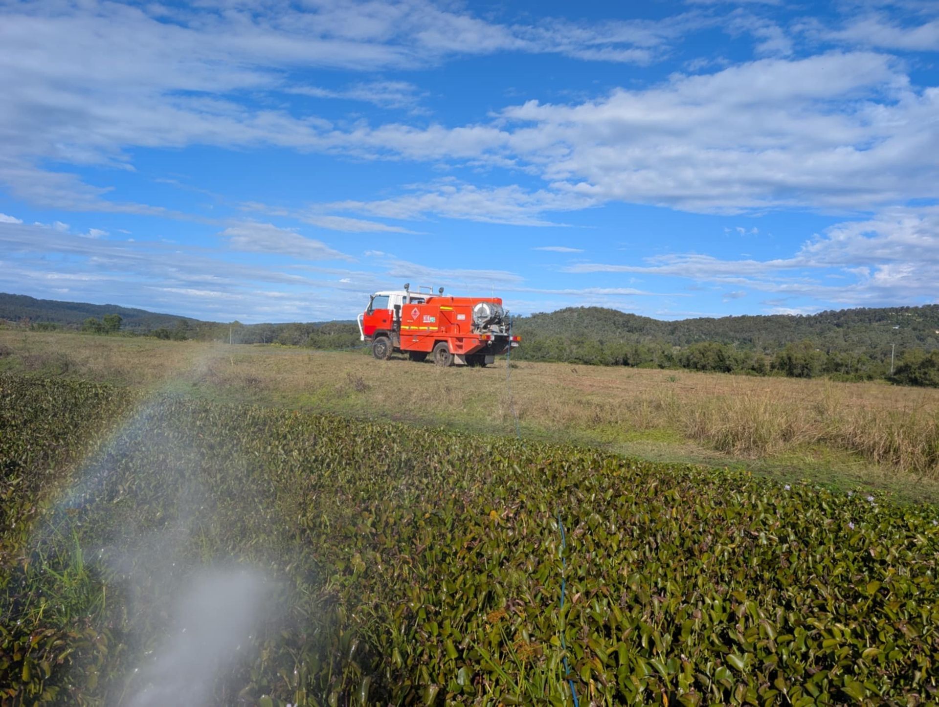 A Man is Using a Lawn Mower on a Path in a Park — 2K Pasture Management and Consulting In Somerset, QLD
