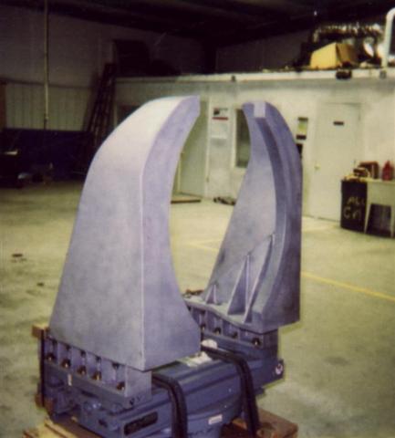 A large gray object is sitting on a pallet in a room