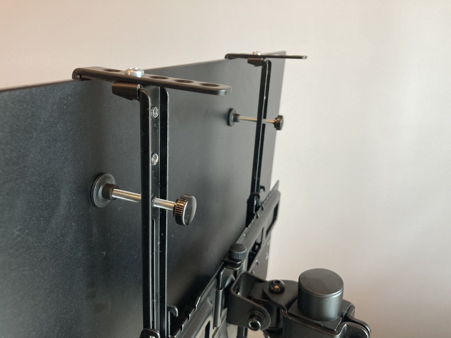A close up of a tv mount on a wall