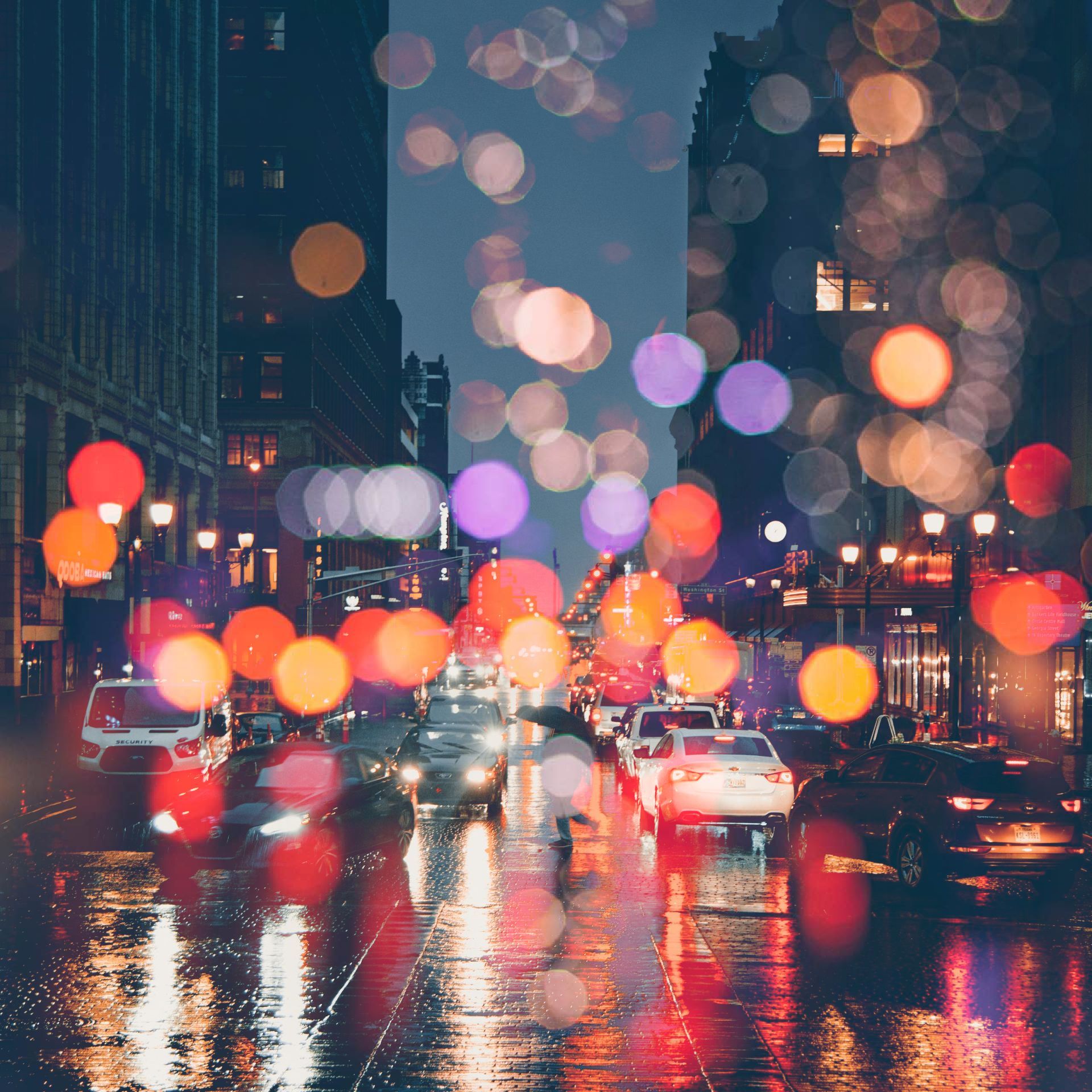 A blurry picture of a city street at night in the rain