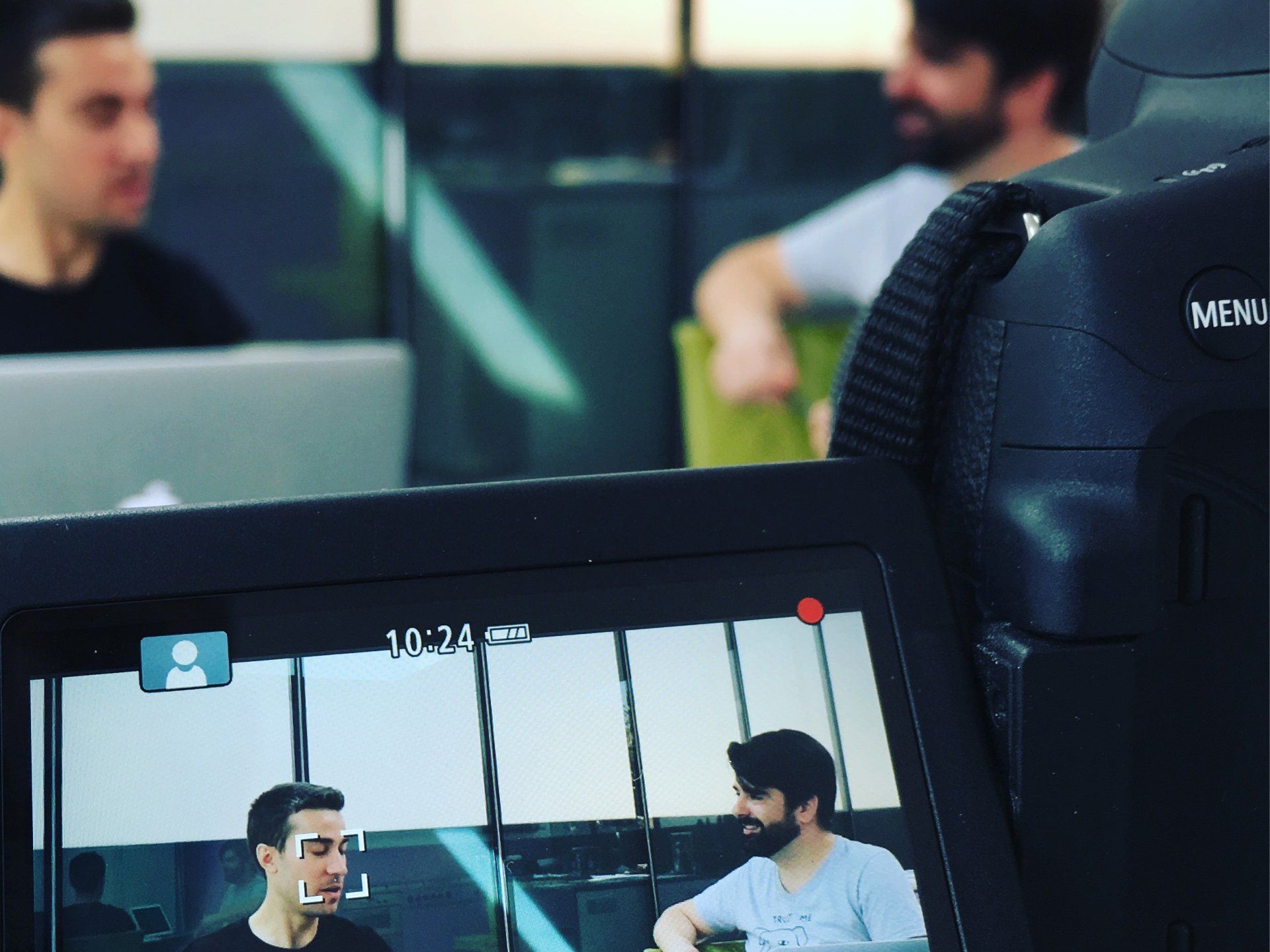 a video camera shows a man talking to another man