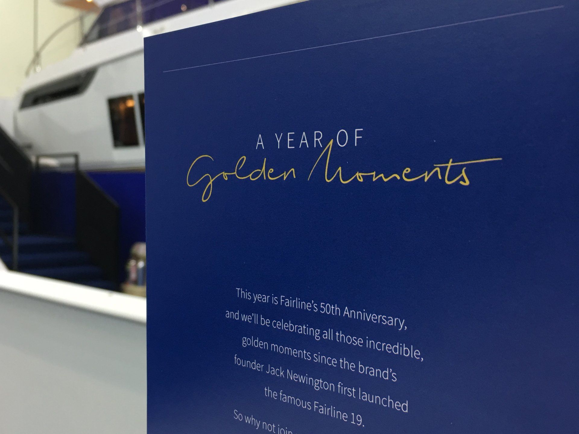 A book titled a year of golden moments with a boat in the background