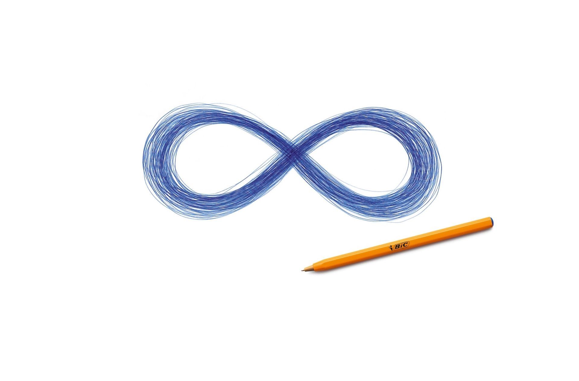 A press ad for BIC titled ‘Infinity’. An orange BIC ballpoint pen rests on a white background, with a meticulously drawn blue infinity symbol above it, formed from continuous overlapping pen strokes. The visual reinforces the idea that this pen never runs out of ink.