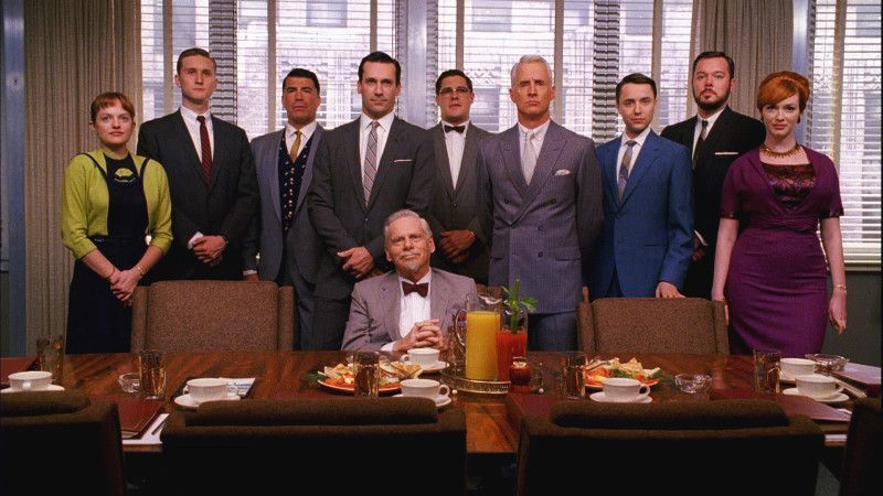 A group of people are posing for a picture in a conference room.