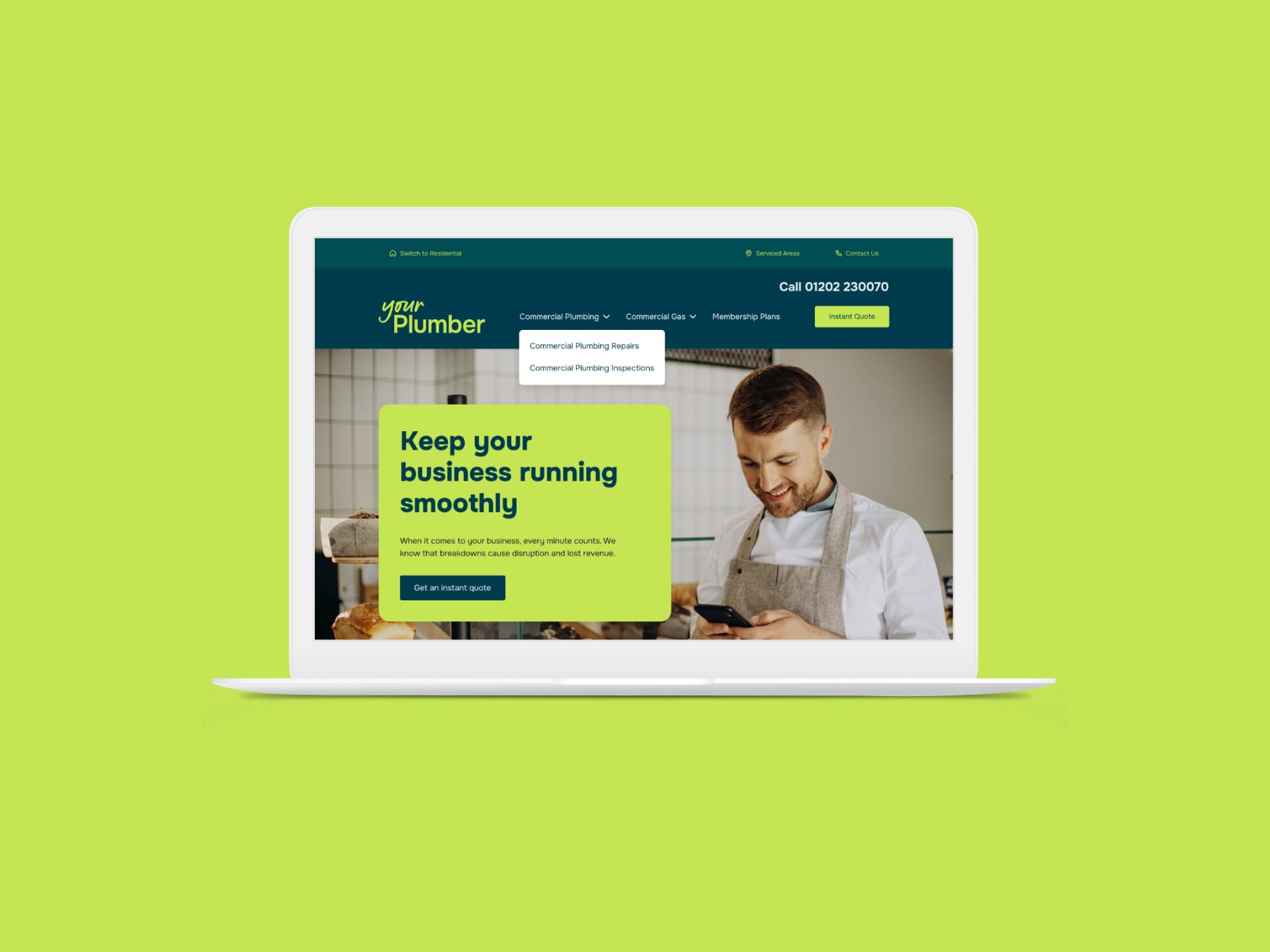 A laptop computer is open to a website with a man looking at his phone.