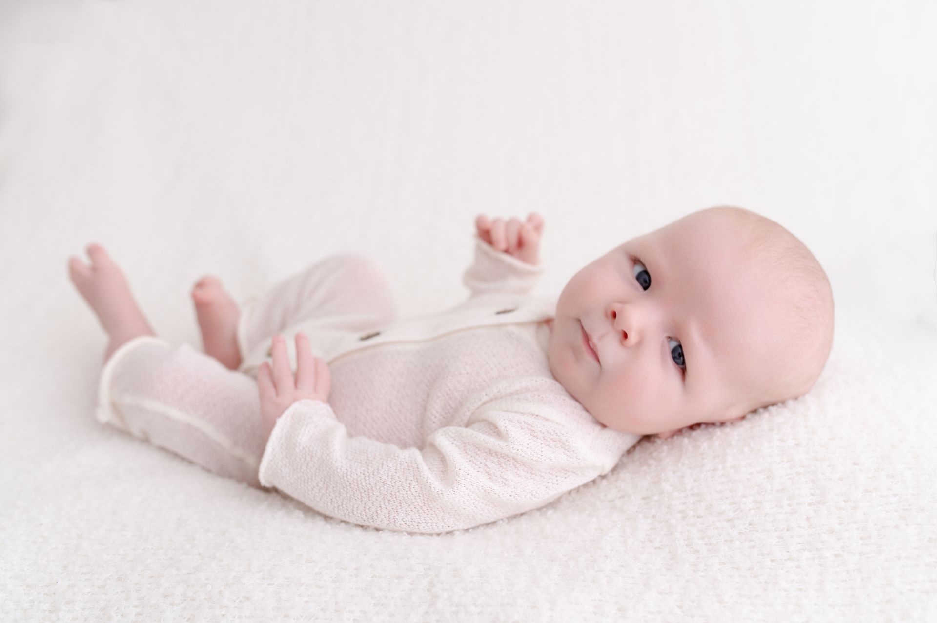 Natural newborn photography with baby boy swaddled in neutral tones – Dublin, Ireland