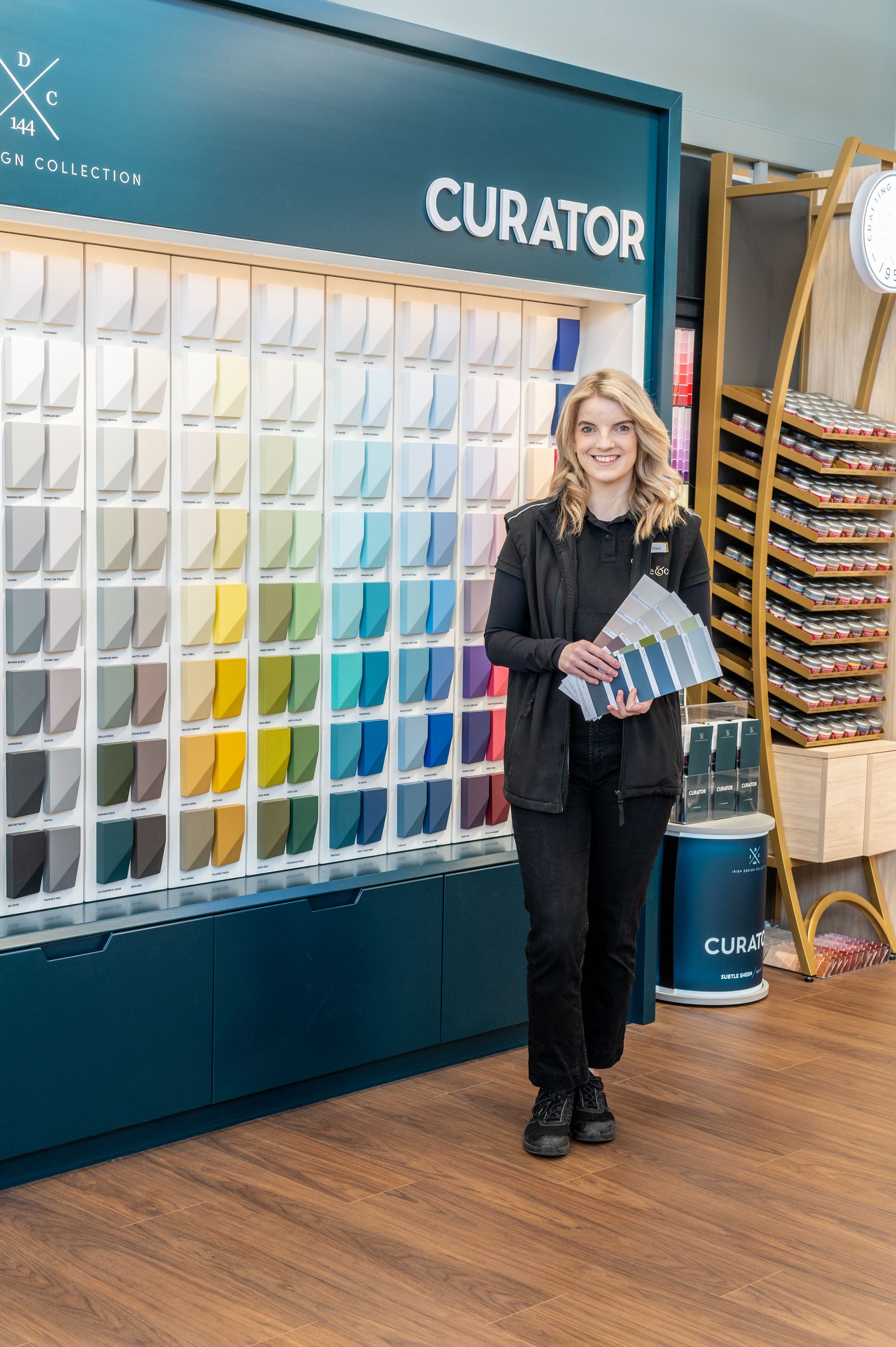 A woman holding paint samples