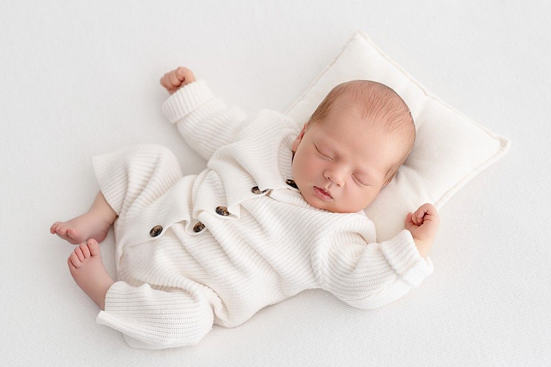 Newborn baby photographed in a neutral studio setting by a Dublin newborn photographer