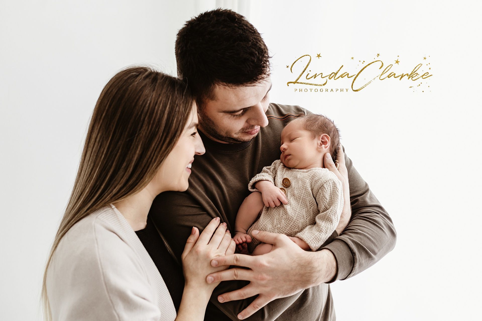 Newborn baby with parents during a newborn photoshoot in dublin Ireland